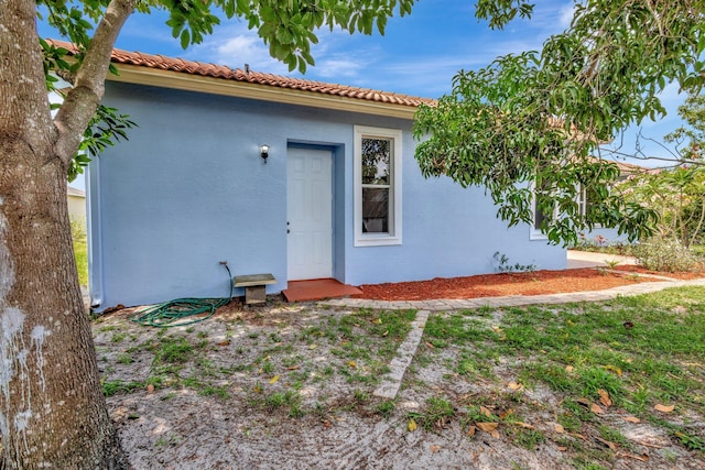 1897 SW Citation Ave, Port Saint Lucie, FL 34953 - property entrance with stucco siding and a tile roof