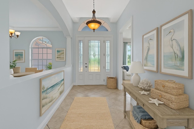 1897 SW Citation Ave, Port Saint Lucie, FL 34953 - foyer with healthy amount of natural light, arched walkways, a chandelier, and light tile patterned flooring
