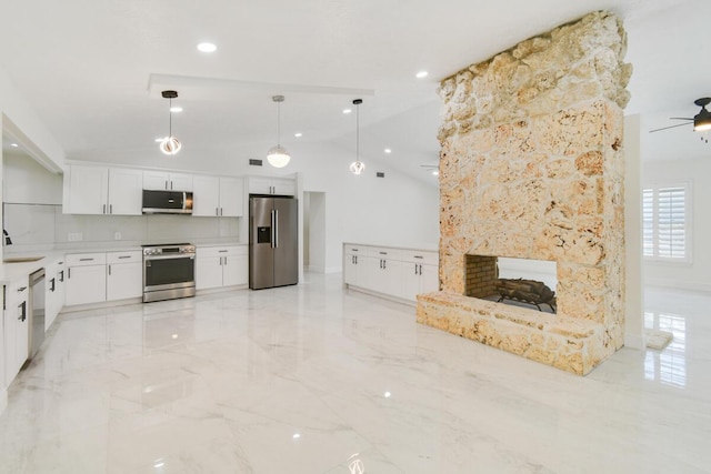 4873 SE Pilot Way, Stuart, FL 34997 - kitchen with stainless steel appliances, a sink, white cabinetry, lofted ceiling, and a ceiling fan