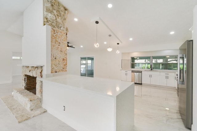 4873 SE Pilot Way, Stuart, FL 34997 - kitchen featuring appliances with stainless steel finishes, a sink, light marble finish floors, white cabinets, and recessed lighting