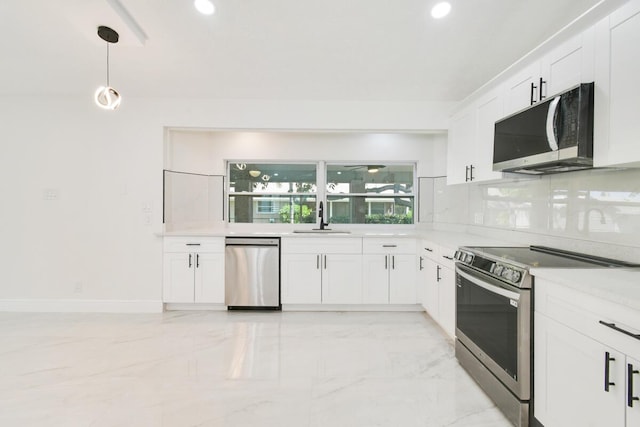 4873 SE Pilot Way, Stuart, FL 34997 - kitchen featuring stainless steel appliances, a sink, light marble finish flooring, white cabinets, and recessed lighting