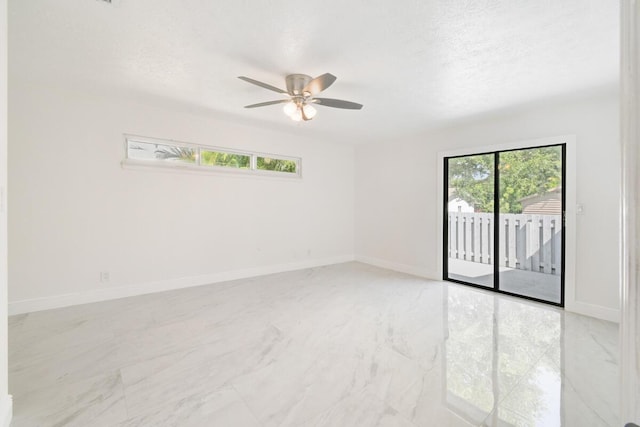 4873 SE Pilot Way, Stuart, FL 34997 - unfurnished room with a ceiling fan, light marble finish flooring, baseboards, and a textured ceiling