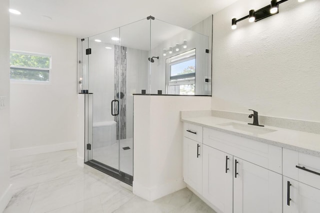 4873 SE Pilot Way, Stuart, FL 34997 - bathroom featuring marble finish flooring, a stall shower, plenty of natural light, and vanity