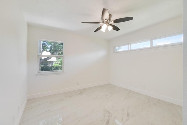 4873 SE Pilot Way, Stuart, FL 34997 - spare room with light marble finish flooring, a ceiling fan, and baseboards