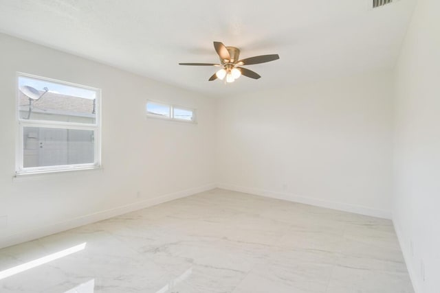 4873 SE Pilot Way, Stuart, FL 34997 - empty room with light marble finish floors, a ceiling fan, and baseboards