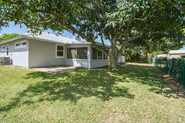 4873 SE Pilot Way, Stuart, FL 34997 - rear view of property featuring central air condition unit, a sunroom, metal roof, and stucco siding