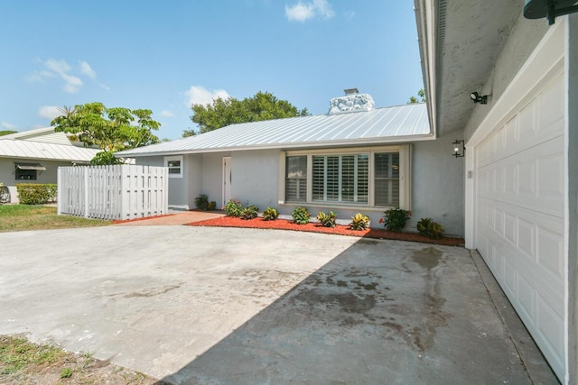 4873 SE Pilot Way, Stuart, FL 34997 - view of front of house featuring metal roof, stucco siding, and a chimney