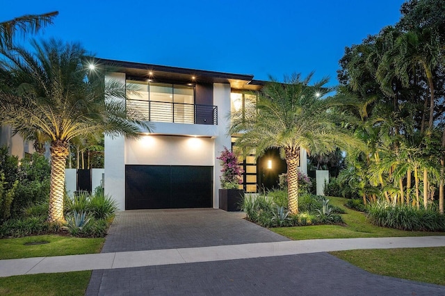 775 Park Dr W, Boca Raton, FL 33432 - view of front of home with a balcony, an attached garage, decorative driveway, and stucco siding