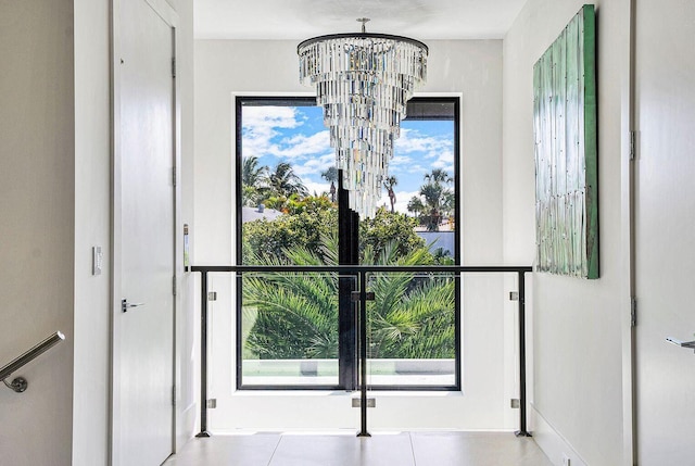 775 Park Dr W, Boca Raton, FL 33432 - hallway with a chandelier and baseboards