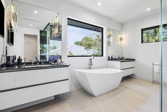 775 Park Dr W, Boca Raton, FL 33432 - bathroom with two vanities, a soaking tub, recessed lighting, and tile patterned floors