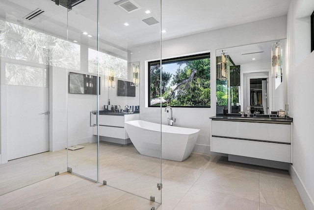 775 Park Dr W, Boca Raton, FL 33432 - full bathroom with vanity, a freestanding bath, recessed lighting, tile patterned floors, and baseboards
