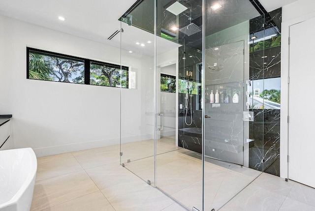 775 Park Dr W, Boca Raton, FL 33432 - bathroom with a marble finish shower, a freestanding tub, healthy amount of natural light, tile patterned flooring, and recessed lighting