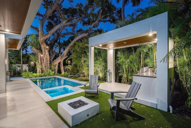775 Park Dr W, Boca Raton, FL 33432 - view of swimming pool with area for grilling, a fire pit, a yard, a pool with connected hot tub, and a patio