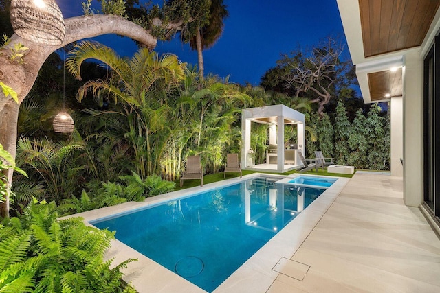 775 Park Dr W, Boca Raton, FL 33432 - pool at twilight featuring a patio and a pool with connected hot tub