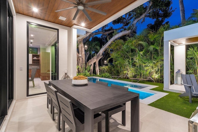 775 Park Dr W, Boca Raton, FL 33432 - patio at twilight with ceiling fan, a patio area, an outdoor pool, and outdoor dining area
