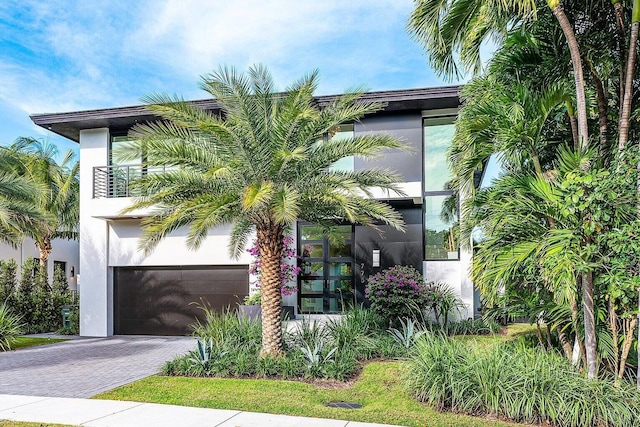 775 Park Dr W, Boca Raton, FL 33432 - view of front facade with decorative driveway, stucco siding, and a garage