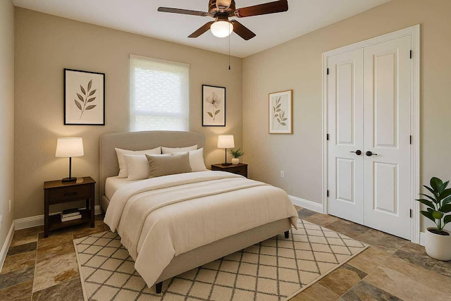 1036 Greenway Ter, Sebring, FL 33876 - bedroom with light stone finish flooring, baseboards, a ceiling fan, and a closet