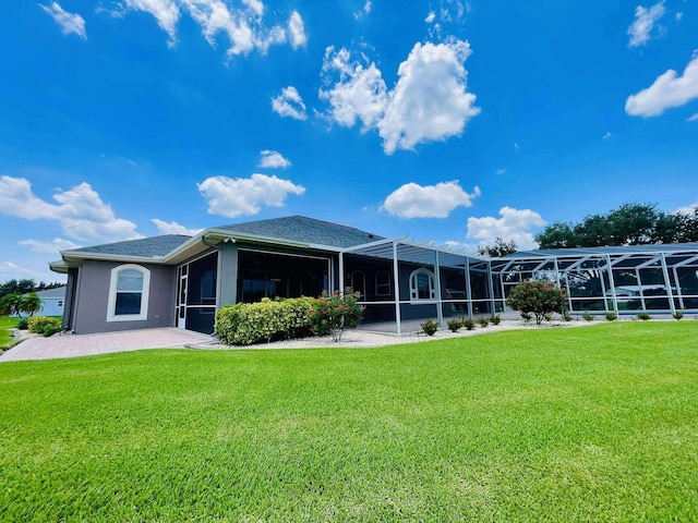 1036 Greenway Ter, Sebring, FL 33876 - rear view of property with a lawn, glass enclosure, stucco siding, and a patio area