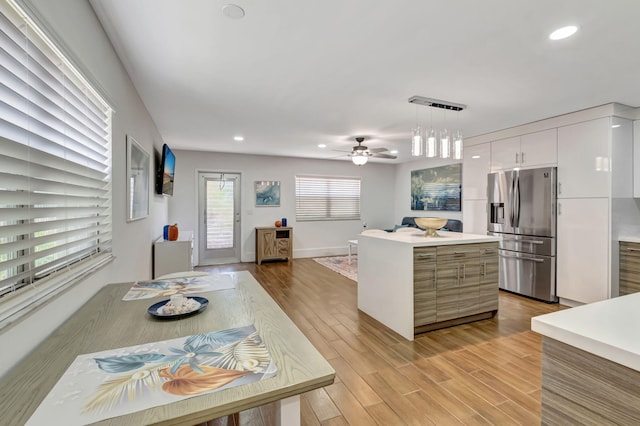 187 Seville H, Delray Beach, FL 33446 - kitchen with stainless steel fridge, light countertops, modern cabinets, a kitchen island, and a ceiling fan