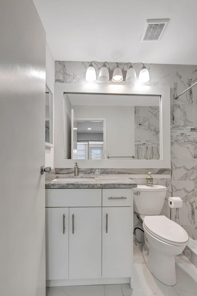 187 Seville H, Delray Beach, FL 33446 - bathroom with marble finish flooring, a marble finish shower, vanity, and toilet