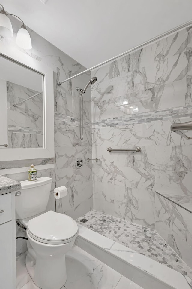 187 Seville H, Delray Beach, FL 33446 - bathroom featuring vanity, toilet, a marble finish shower, and marble finish flooring