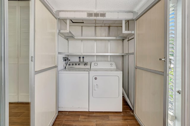 187 Seville H, Delray Beach, FL 33446 - laundry area featuring independent washer and dryer, wood finish floors, and healthy amount of natural light