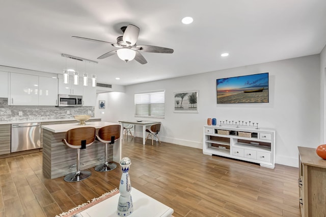 187 Seville H, Delray Beach, FL 33446 - kitchen featuring appliances with stainless steel finishes, modern cabinets, ceiling fan, white cabinetry, and light countertops