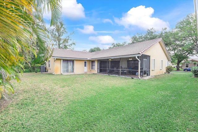 2326 NW 96th Way, Coral Springs, FL 33065 - back of house with a tiled roof, central air condition unit, a sunroom, and a lawn