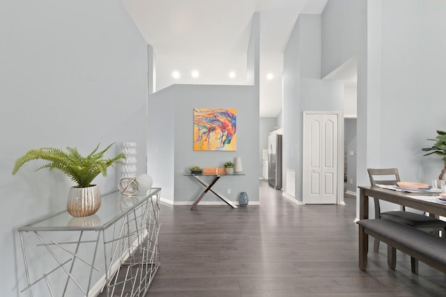3288 SW Majestic Ct, Palm City, FL 34990 - hallway with high vaulted ceiling, wood finished floors, and baseboards