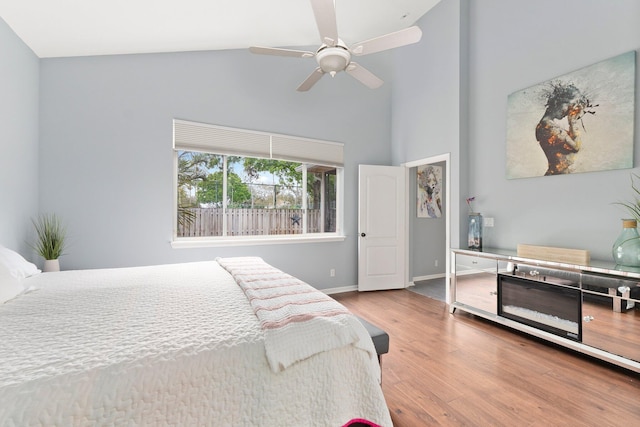 3288 SW Majestic Ct, Palm City, FL 34990 - bedroom featuring wood finished floors, high vaulted ceiling, baseboards, and ceiling fan