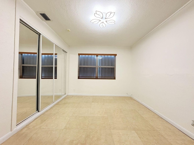 1034 Almeria Rd, West Palm Beach, FL 33405 - spare room featuring a textured ceiling and baseboards