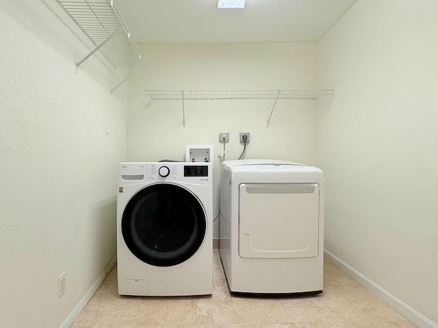 1034 Almeria Rd, West Palm Beach, FL 33405 - laundry area with washer and dryer and baseboards