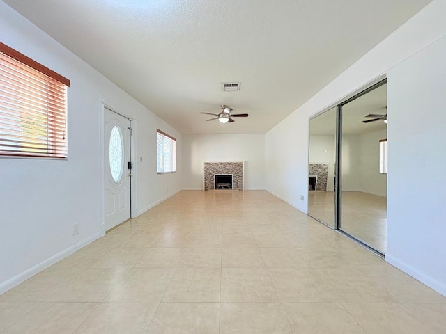 1034 Almeria Rd, West Palm Beach, FL 33405 - unfurnished living room with a fireplace, a ceiling fan, and baseboards