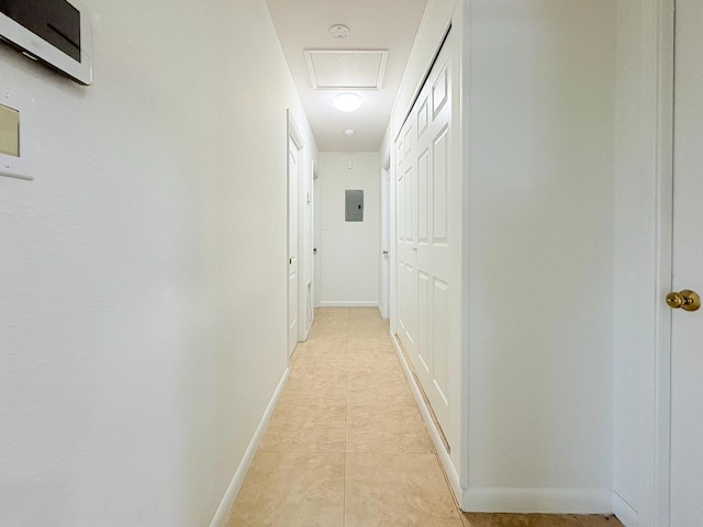1034 Almeria Rd, West Palm Beach, FL 33405 - corridor with electric panel, attic access, baseboards, and light tile patterned floors