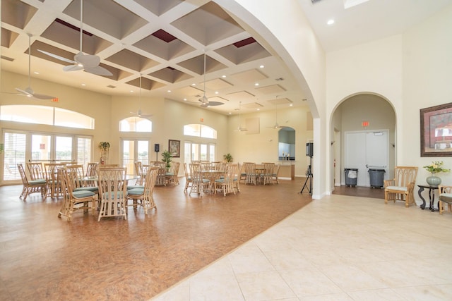 5704 Spanish River Rd, Fort Pierce, FL 34951 - dining space featuring a towering ceiling, coffered ceiling, a ceiling fan, light tile patterned flooring, and beamed ceiling