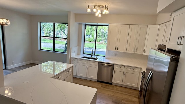 5800 Coach House Cir Unit B, Boca Raton, FL 33486 - kitchen with appliances with stainless steel finishes, a sink, wood finished floors, white cabinetry, and tasteful backsplash
