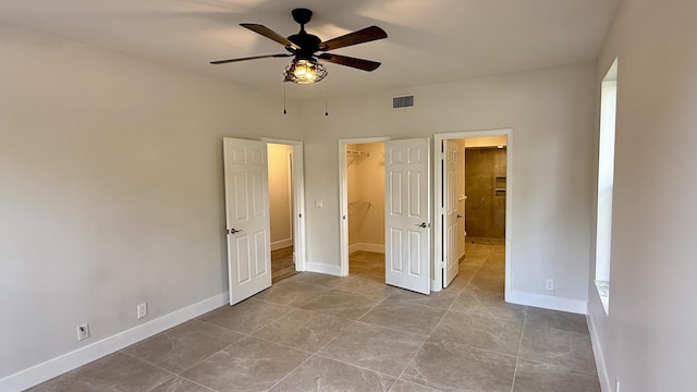 5800 Coach House Cir Unit B, Boca Raton, FL 33486 - unfurnished bedroom with a walk in closet, baseboards, a closet, ensuite bath, and ceiling fan