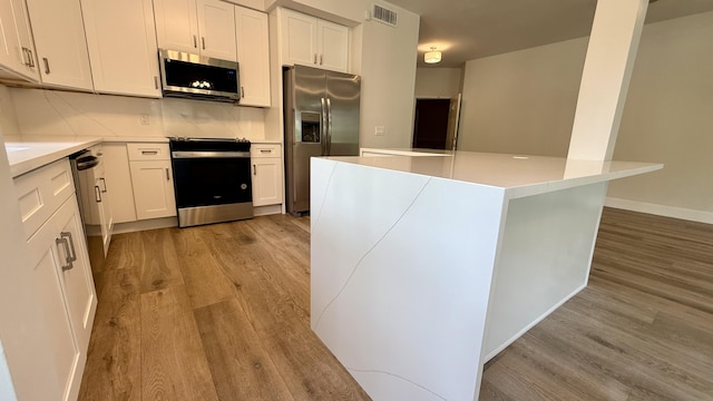5800 Coach House Cir Unit B, Boca Raton, FL 33486 - kitchen with stainless steel appliances, light wood finished floors, white cabinetry, and light countertops