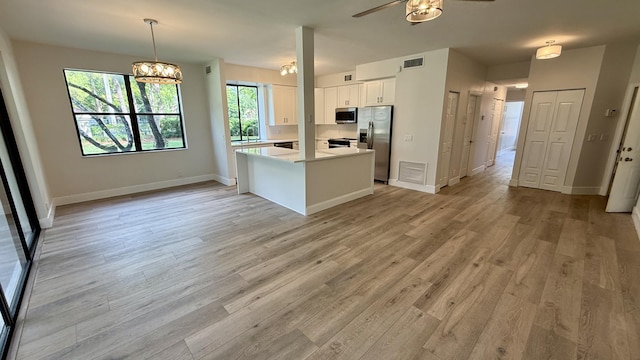 5800 Coach House Cir Unit B, Boca Raton, FL 33486 - kitchen with stainless steel appliances, white cabinets, light countertops, light wood-style flooring, and baseboards