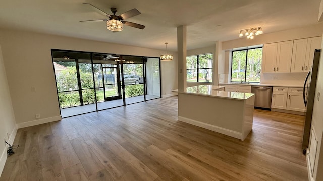 5800 Coach House Cir Unit B, Boca Raton, FL 33486 - kitchen with stainless steel appliances, open floor plan, a sink, baseboards, and white cabinetry
