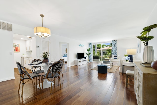 354 Chilean Ave Unit 3E, Palm Beach, FL 33480 - dining room with dark wood-type flooring, a chandelier, and baseboards