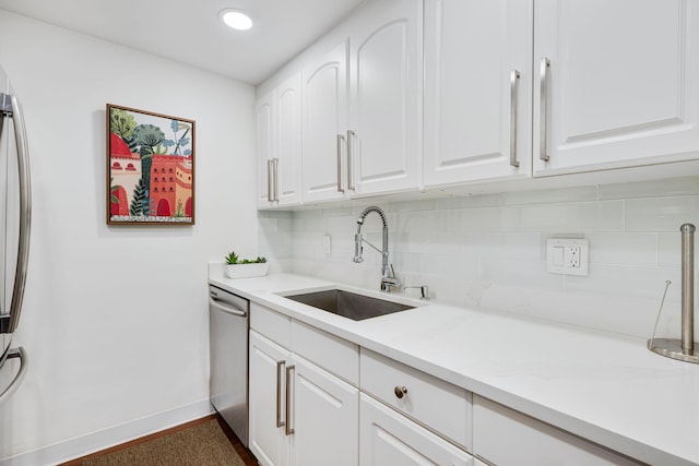 354 Chilean Ave Unit 3E, Palm Beach, FL 33480 - kitchen with a sink, stainless steel appliances, decorative backsplash, white cabinetry, and baseboards
