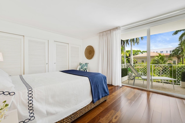 354 Chilean Ave Unit 3E, Palm Beach, FL 33480 - bedroom with access to outside, wood-type flooring, expansive windows, and two closets