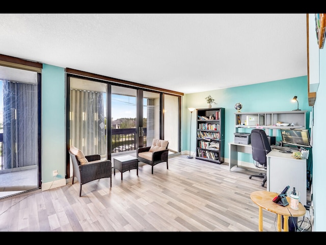 2400 Presidential Way Unit 401, West Palm Beach, FL 33401 - office featuring light wood-type flooring, baseboards, and a wall of windows