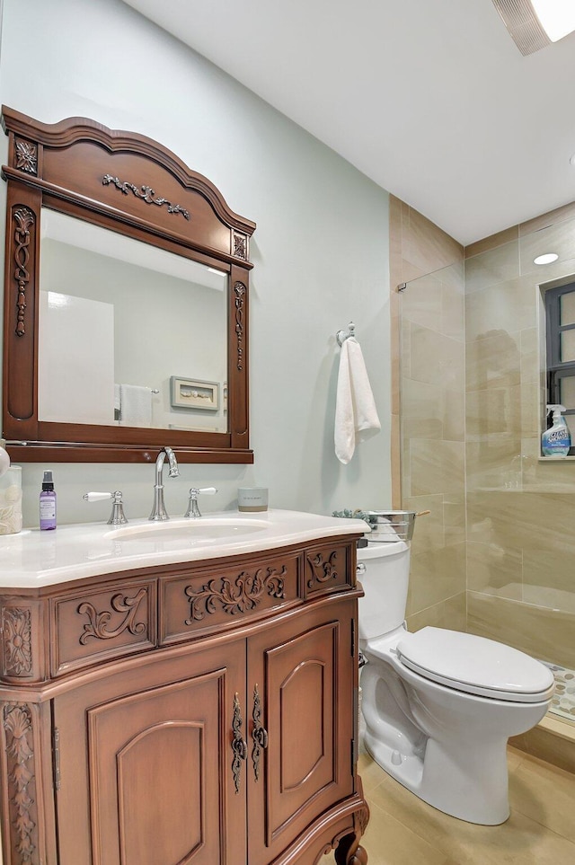 438 Pine Villa Dr, Atlantis, FL 33462 - bathroom featuring toilet, a tile shower, vanity, and tile patterned flooring