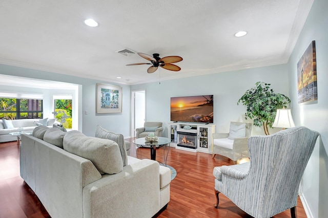438 Pine Villa Dr, Atlantis, FL 33462 - living area with ceiling fan, a glass covered fireplace, wood finished floors, recessed lighting, and baseboards
