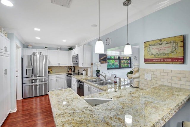 438 Pine Villa Dr, Atlantis, FL 33462 - kitchen featuring stainless steel appliances, a sink, a peninsula, backsplash, and light stone countertops