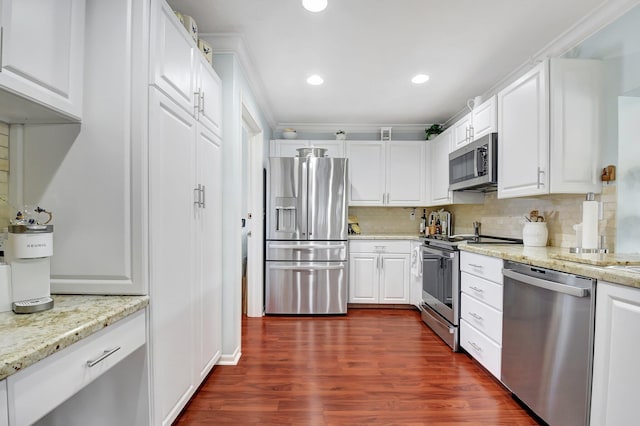 438 Pine Villa Dr, Atlantis, FL 33462 - kitchen with stainless steel appliances, tasteful backsplash, dark wood-style flooring, white cabinetry, and recessed lighting