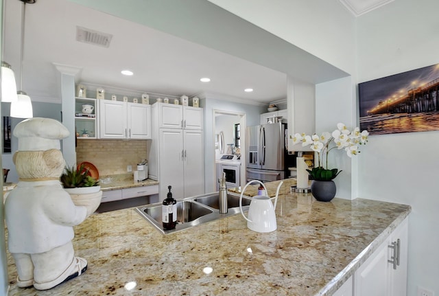 438 Pine Villa Dr, Atlantis, FL 33462 - kitchen with stainless steel fridge, ornamental molding, tasteful backsplash, white cabinets, and open shelves