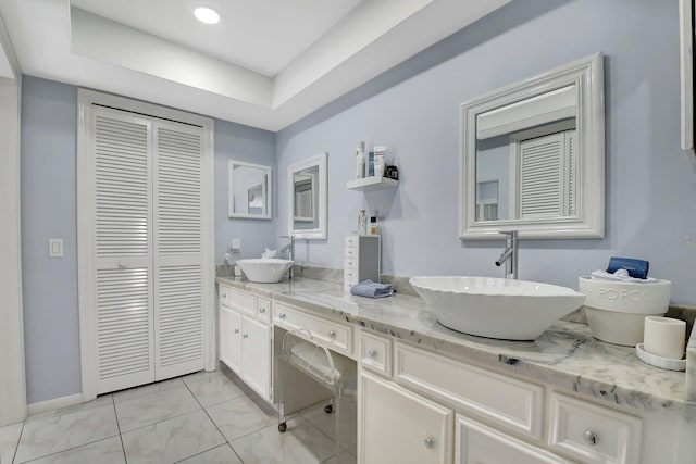438 Pine Villa Dr, Atlantis, FL 33462 - full bathroom featuring a closet, double vanity, baseboards, and marble finish flooring